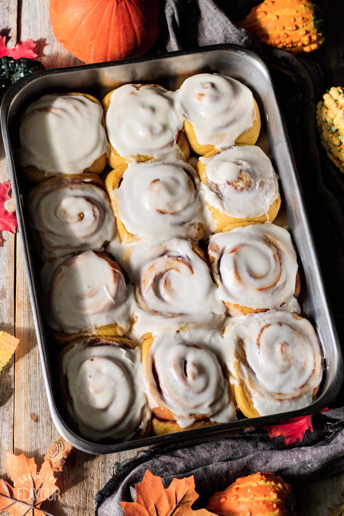baked vegan pumpkin cinnamon rolls with frosting