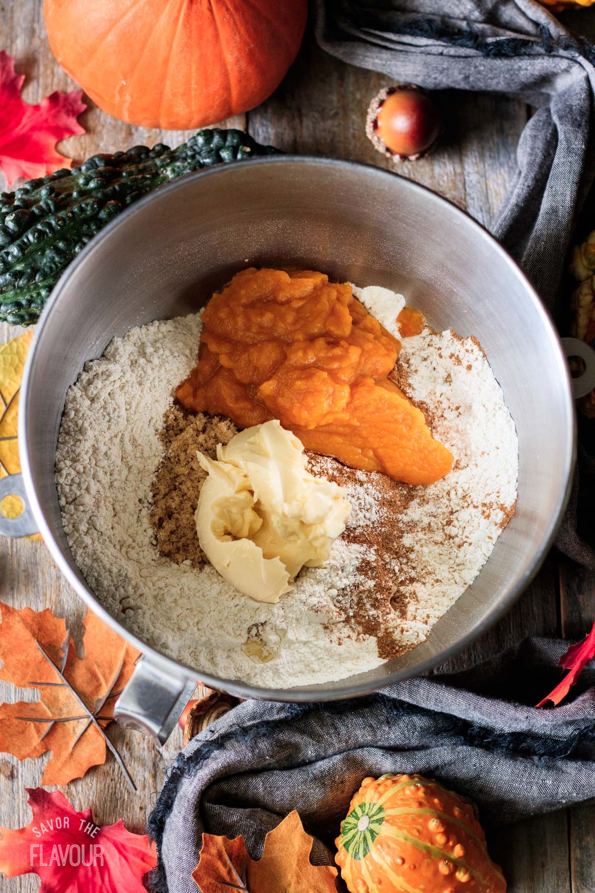 adding the pumpkin, spice, butter, and sugar to flour mixture