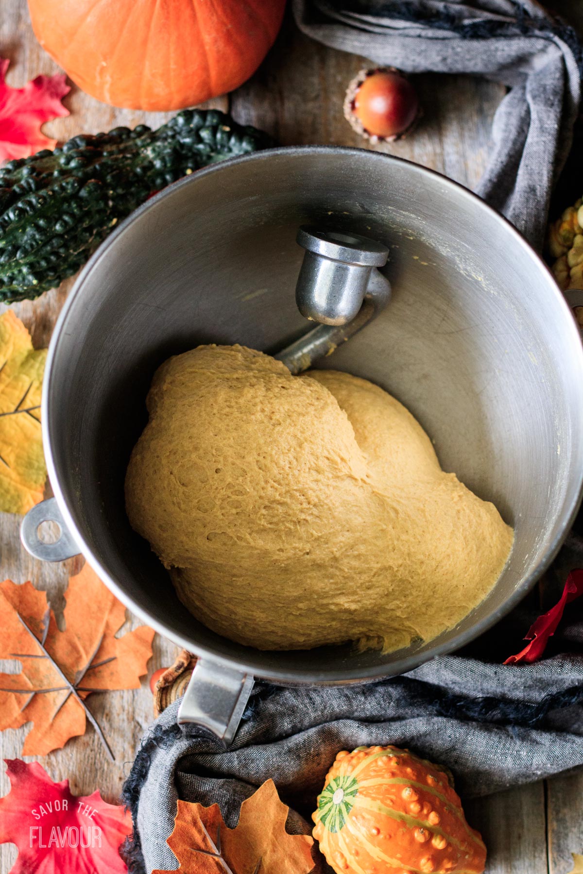 kneaded pumpkin dough in a mixing bowl with the mixer's dough hook