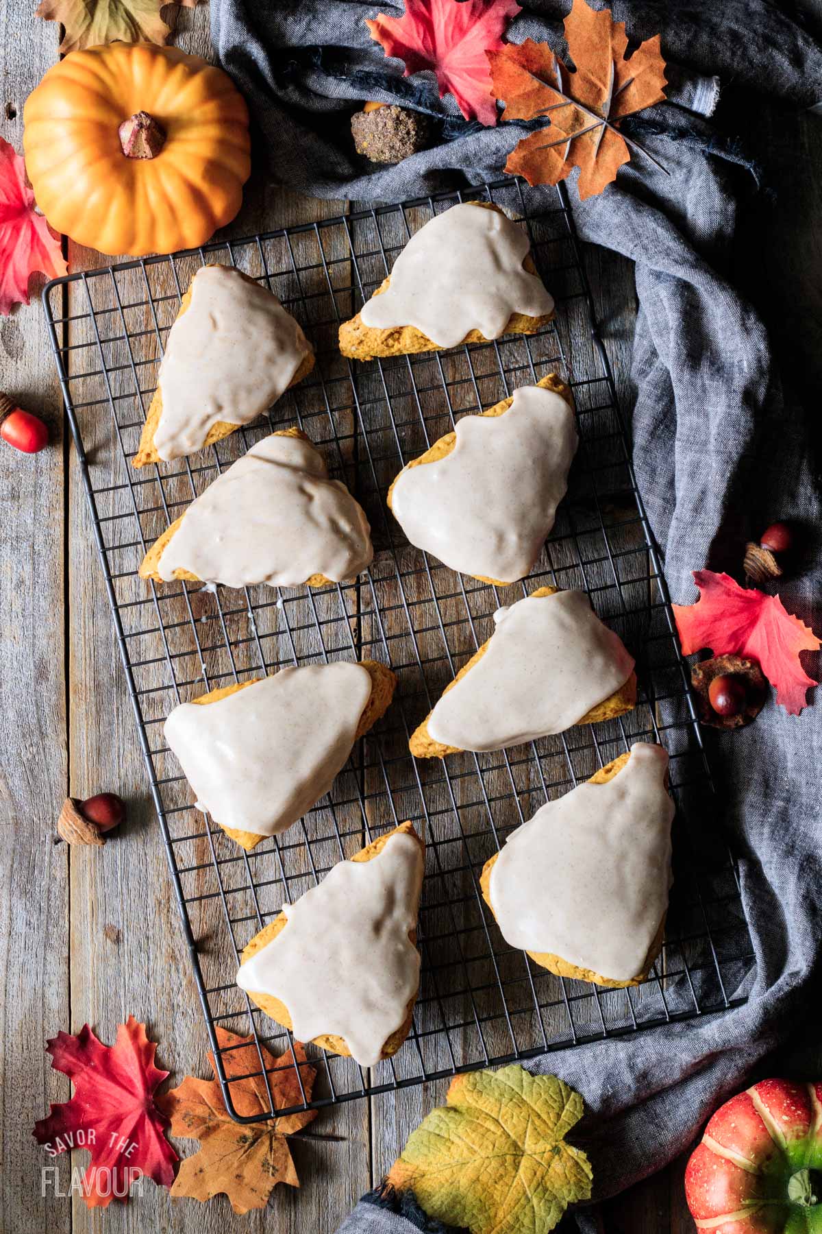glazed pumpkin scones on a wire cooling rack