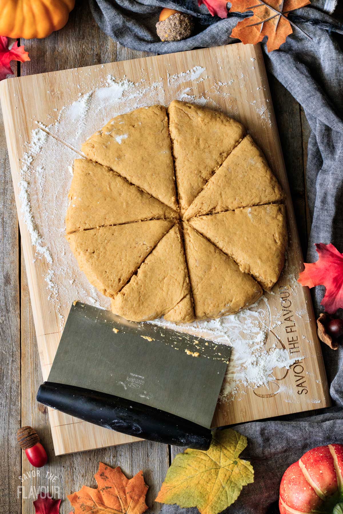 cutting pumpkin scone dough into 8 triangles