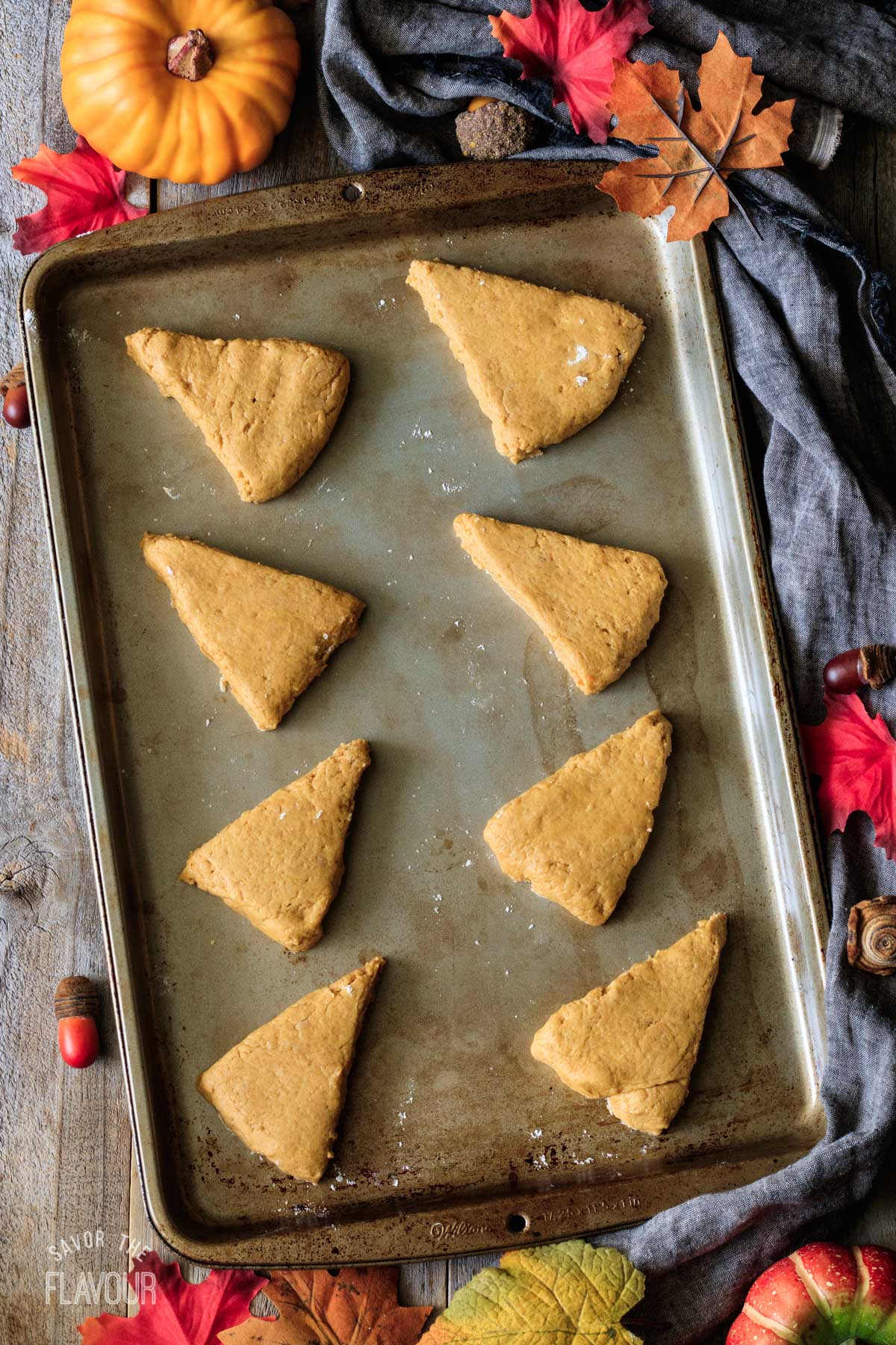 unbaked pumpkin scones on a cookie sheet
