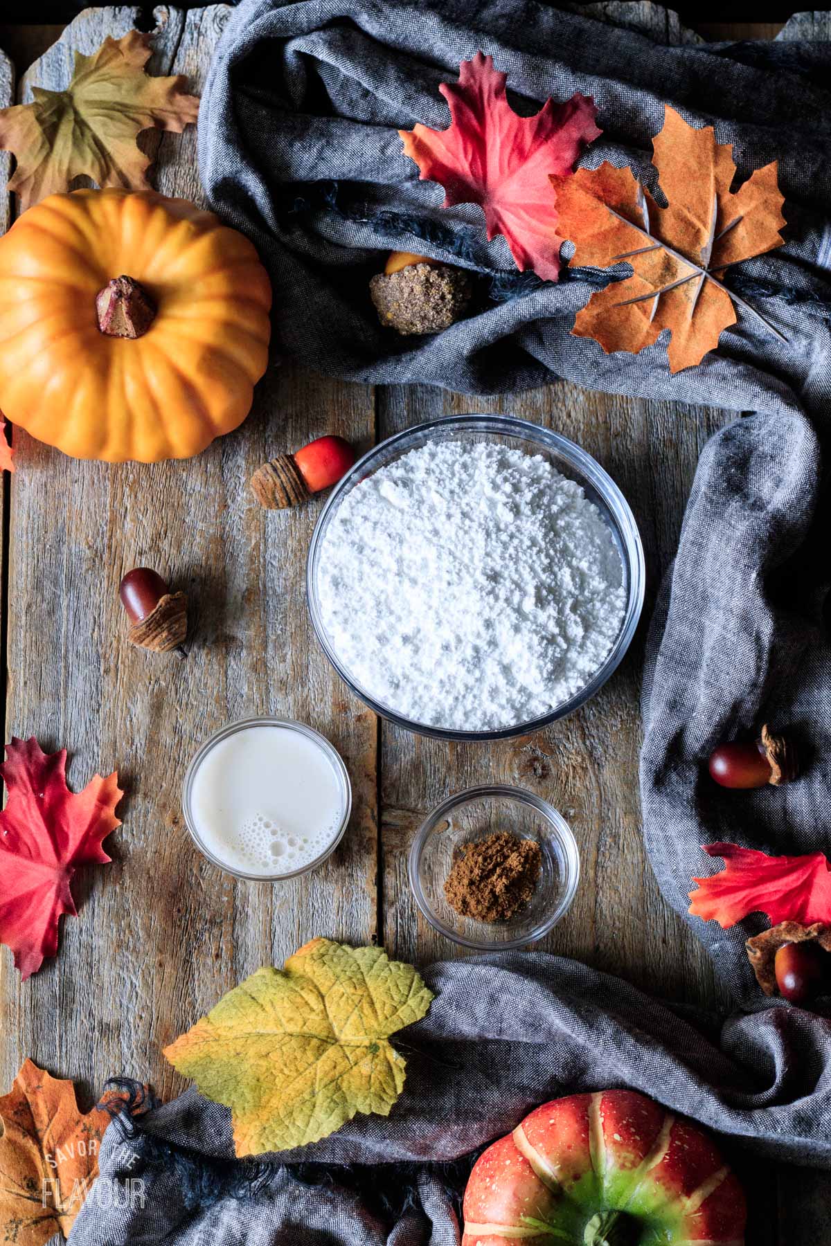bowls of powdered sugar, pumpkin spice, and almond milk