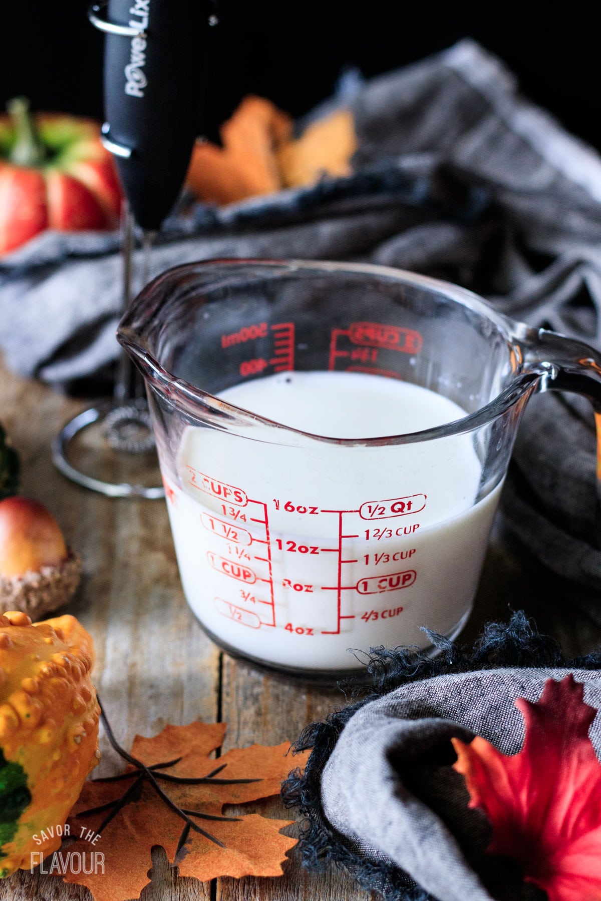 glass measuring cup filled with milk