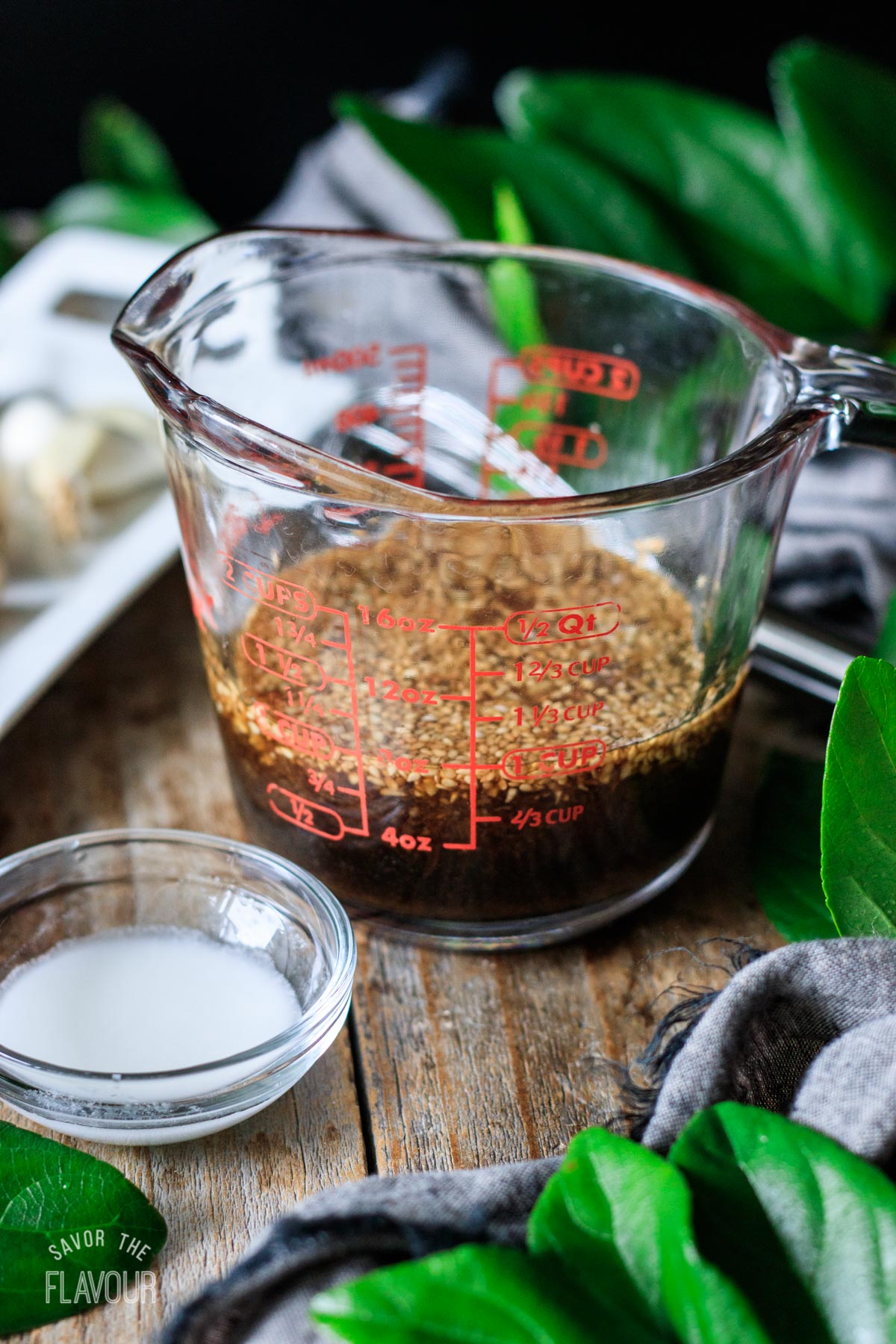glass measuring cup filled with vegan stir fry sauce