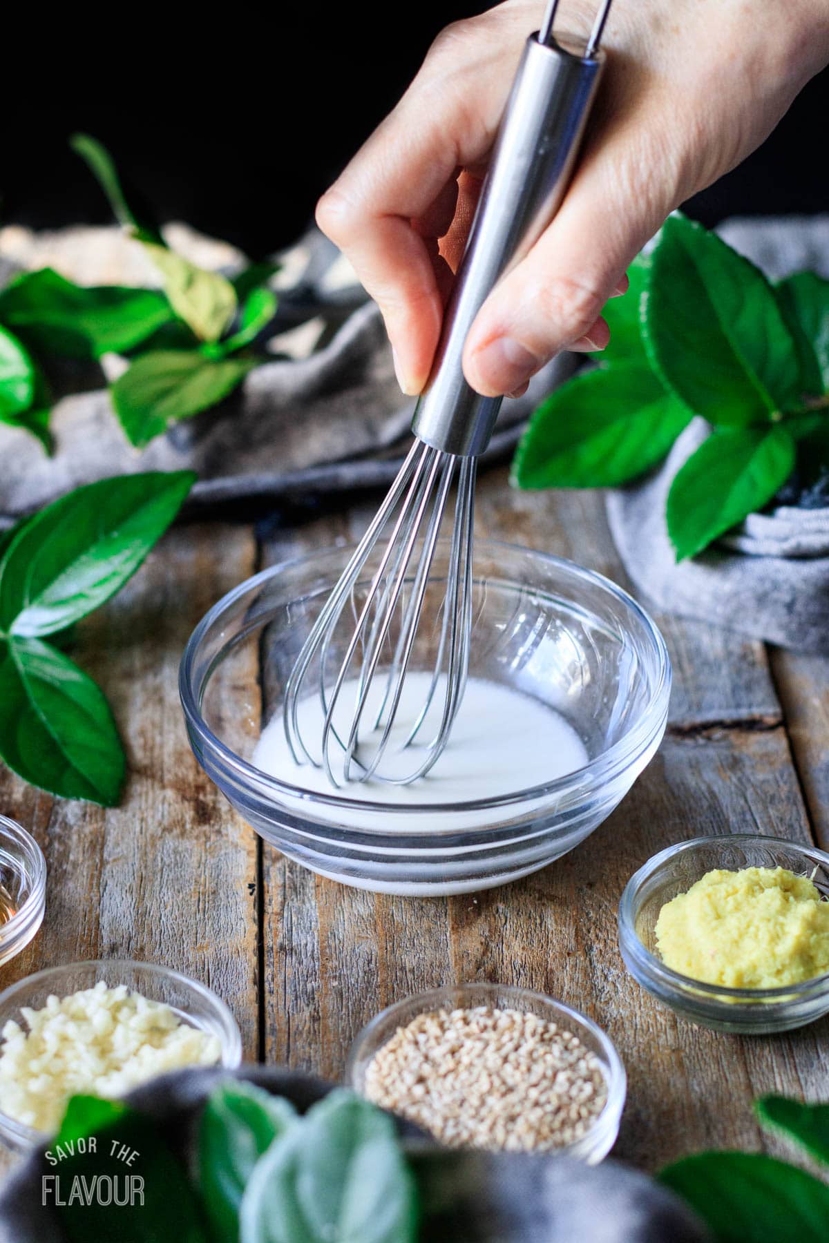 person whisking a cornstarch slurry in a small bowl