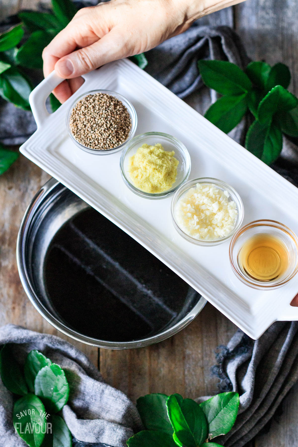 person holding a tray of ingredients for the stir fry sauce