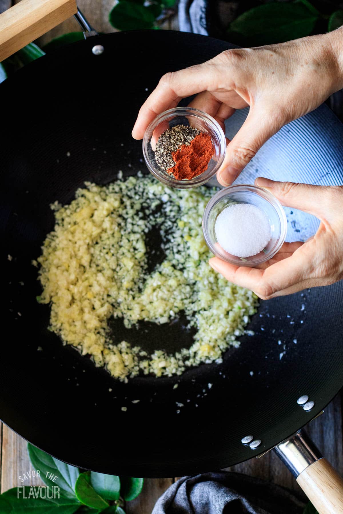 person holding bowls of dried spices
