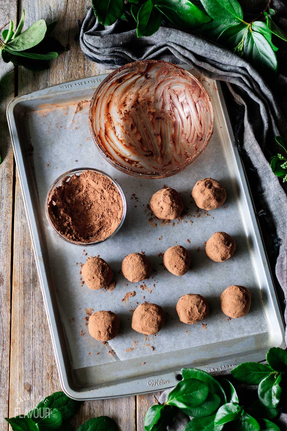 chocolate raspberry truffles on a cookie sheet