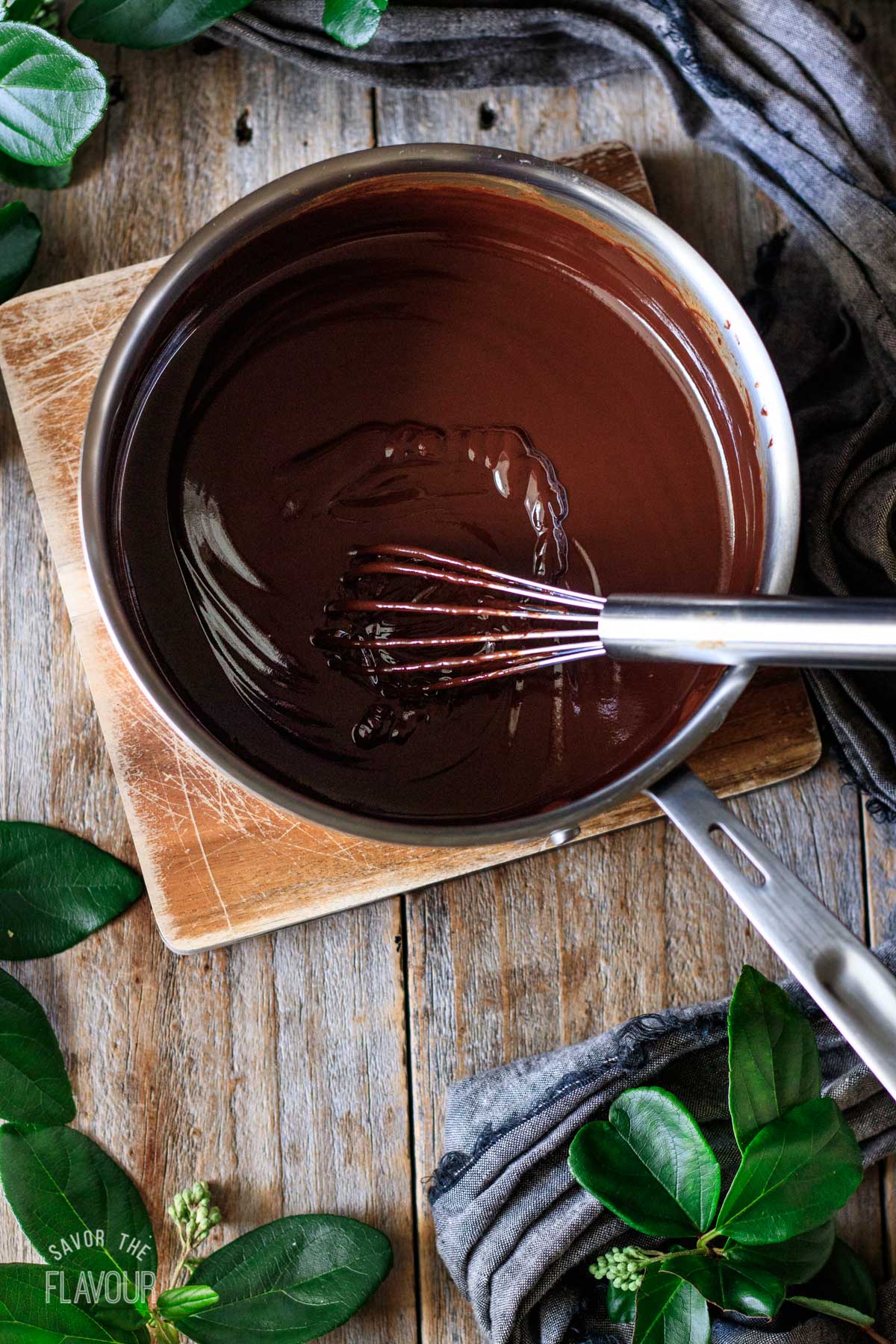 coffee chocolate ganache in a saucepan with a whisk