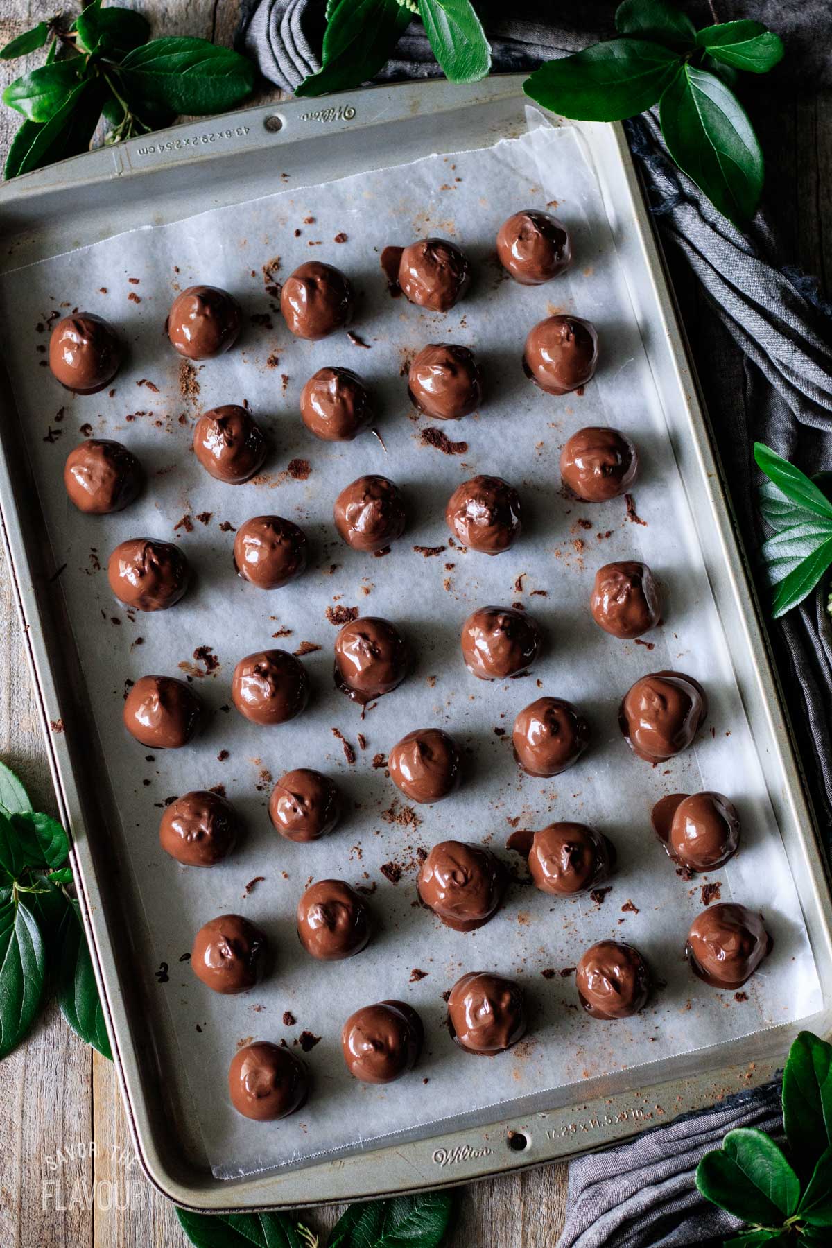 chocolate-dipped coffee truffles on a cookie sheet