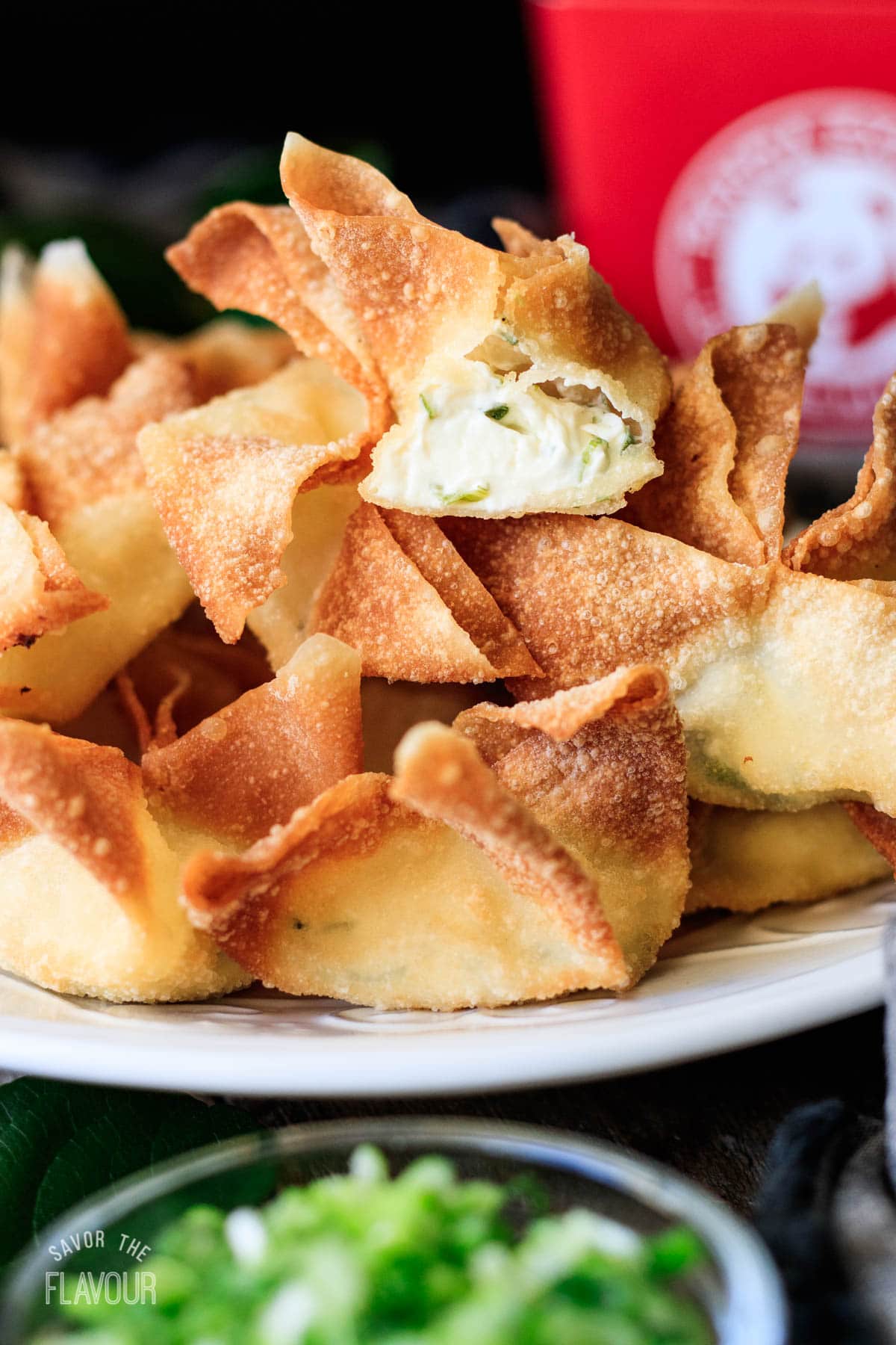 plate of cream cheese rangoons with one cut in half