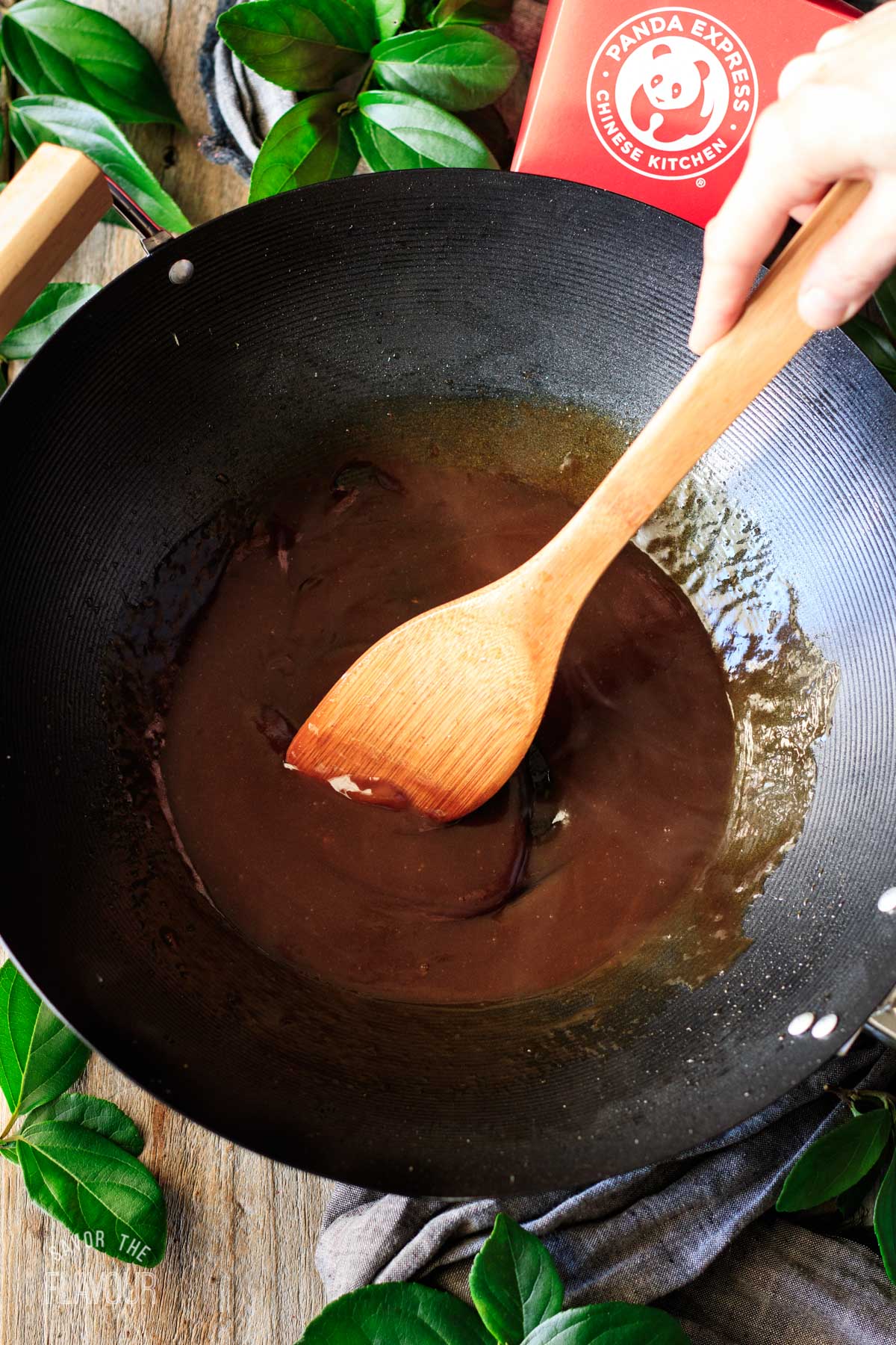 person stirring the Kung Pao sauce in the wok