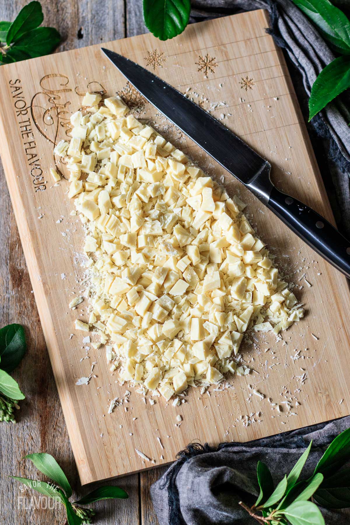 chopped white chocolate on a cutting board with a knife