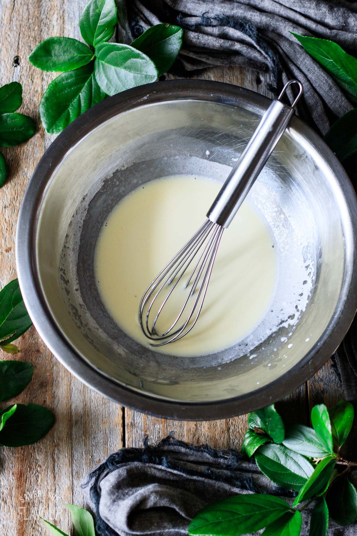 heated cream and melted butter mixture with a whisk