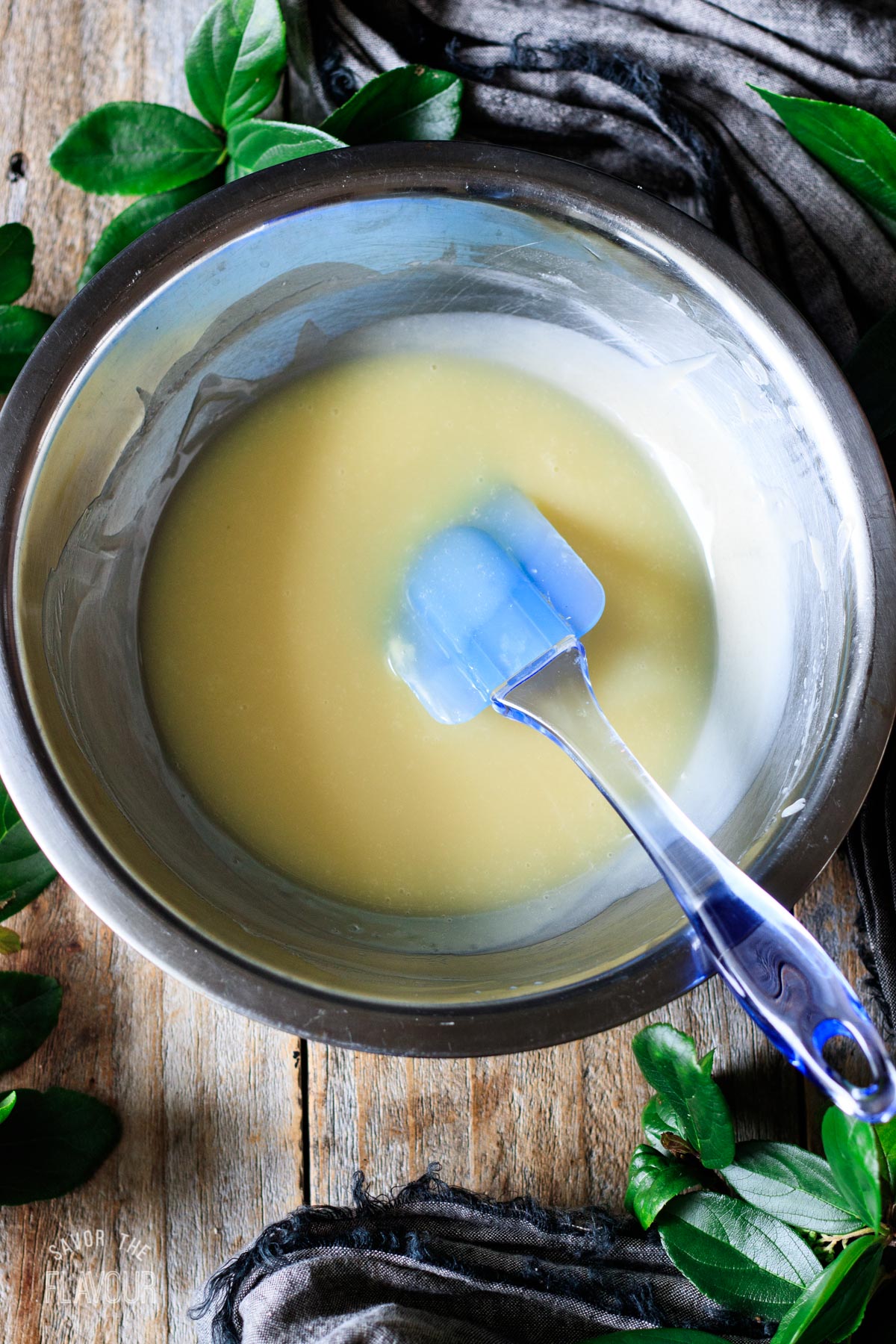 white chocolate ganache in a shallow bowl with a spatula