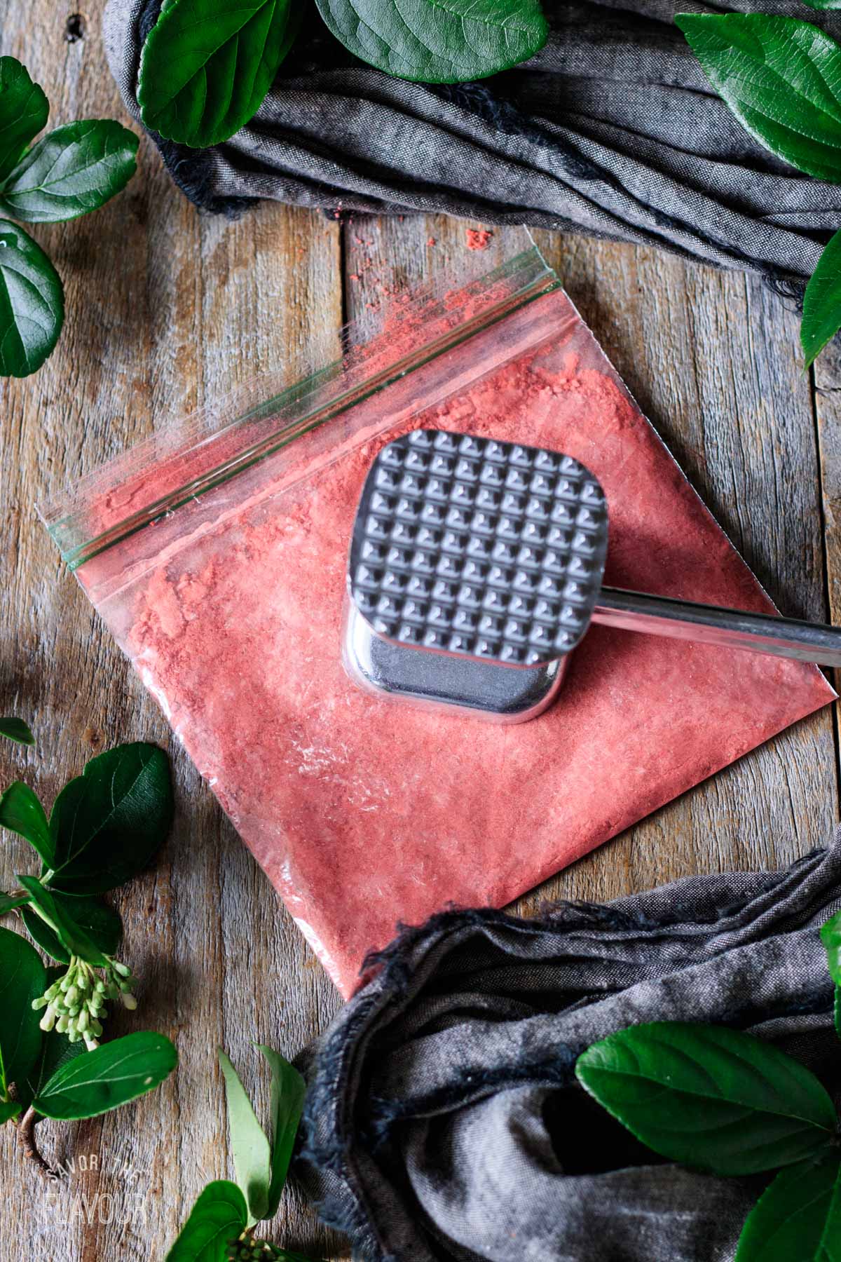 crushing freeze dried strawberries with a meat mallet