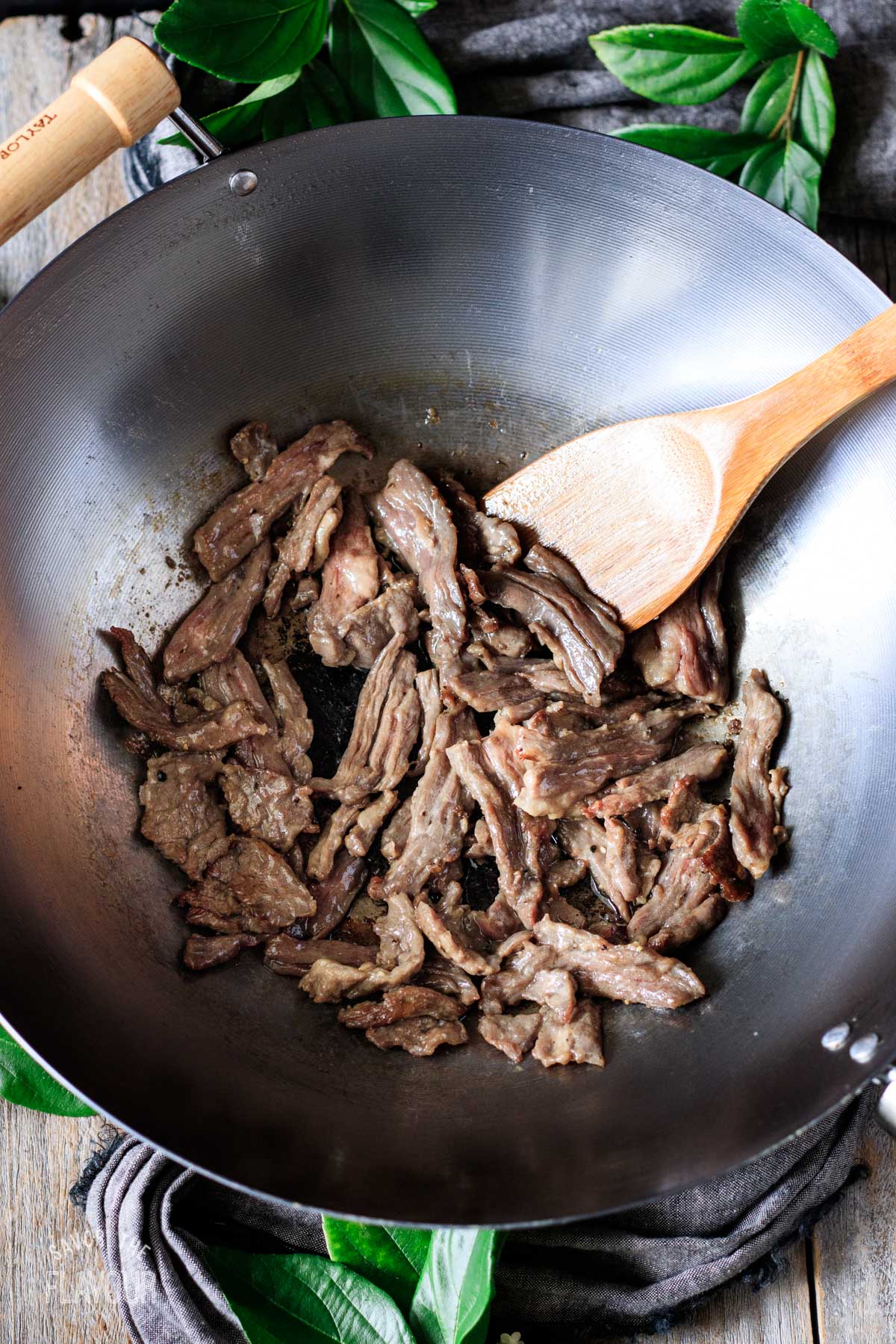 cooked beef strips in a large wok