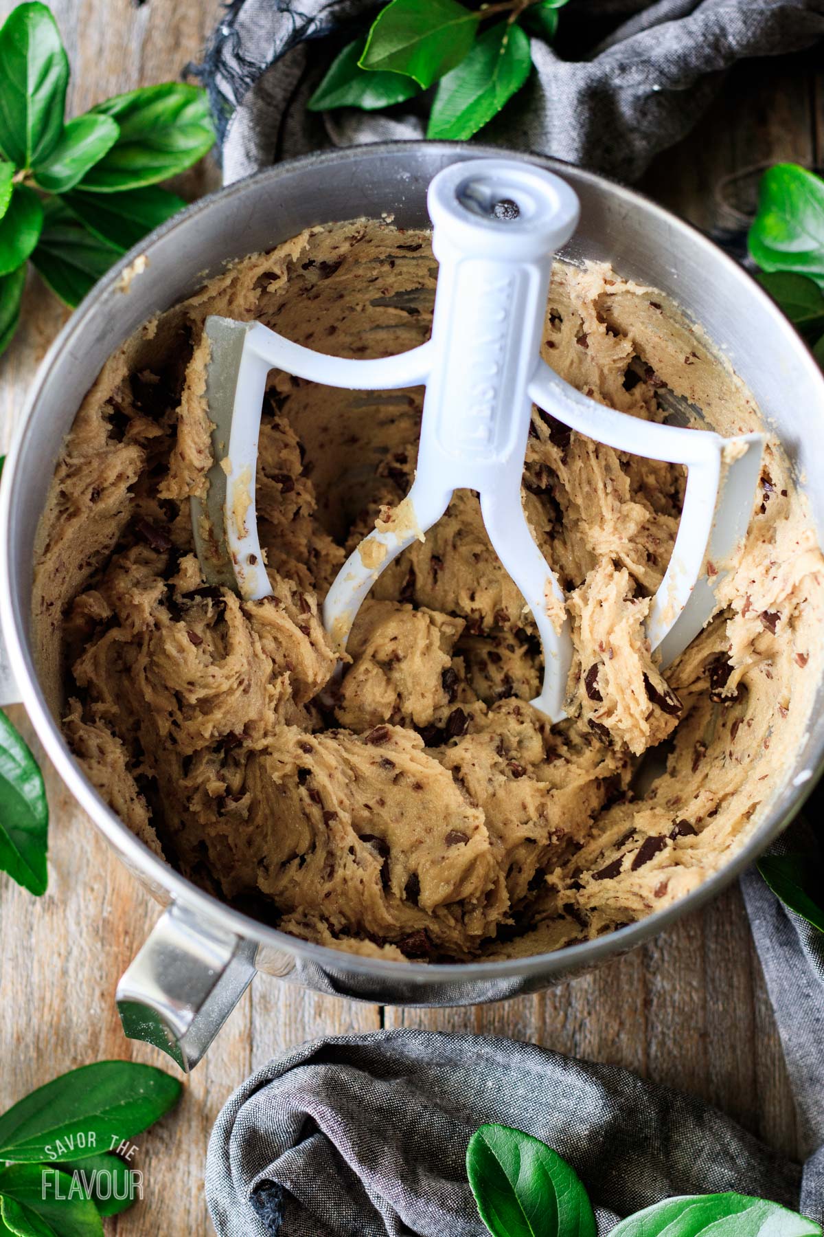 mixing bowl of cookie dough with the chocolate chunks mixed in