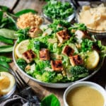 bowl of lemon kale Caesar salad with a fork