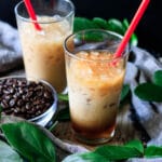 two glasses of Chick-fil-A iced coffee with a bowl of coffee beans