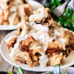 person holding a forkful of bread pudding