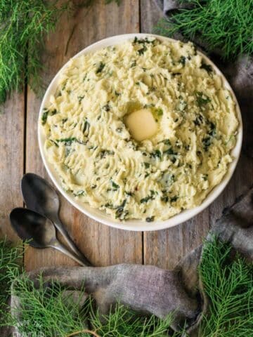 bowl of Irish colcannon with two black spoons