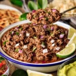 person holding a spoonful of Chipotle barbacoa