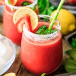 a glass of frozen strawberry lemonade with a straw