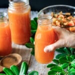 person holding a bottle of seafood stock
