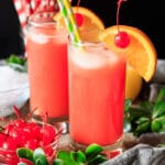 two glasses of Shirley Temple with a bowl of cherries
