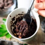 person holding a forkful of brownie mug cake