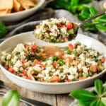 person holding a spoonful of nopales salad
