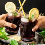 people doing a toast with glasses of cherry lemonade