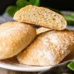 stack of ciabatta rolls on a white plate