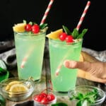 person holding a glass of mint julep