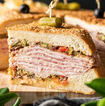 slice of muffaletta sandwich on a cutting board