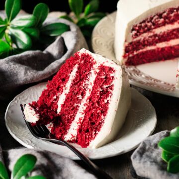 slice of red velvet cake on a plate with a fork