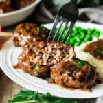 closeup of a Salisbury steak patty on a fork