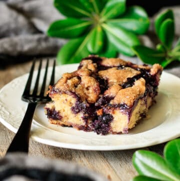 square of blueberry coffee cake on a white plate