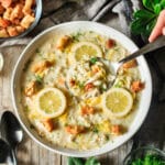 person holding a spoonful of Greek lemon chicken soup