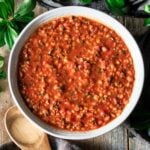 bowl of hamburger barley soup with a wooden spoon