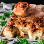 person holding a pecan sticky bun