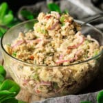 person holding a spoonful of tuna salad