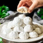 person holding a Mexican wedding cookie