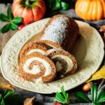 three slices of pumpkin roll with the cake on a platter