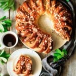 baked Swedish tea ring on a plate with a cup of coffee