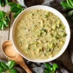 bowl of broccoli Stilton soup with a wooden spoon