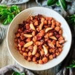 white bowl of roasted sweet potatoes with cranberries