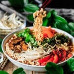 person holding noodles with chopsticks from vegan ramen